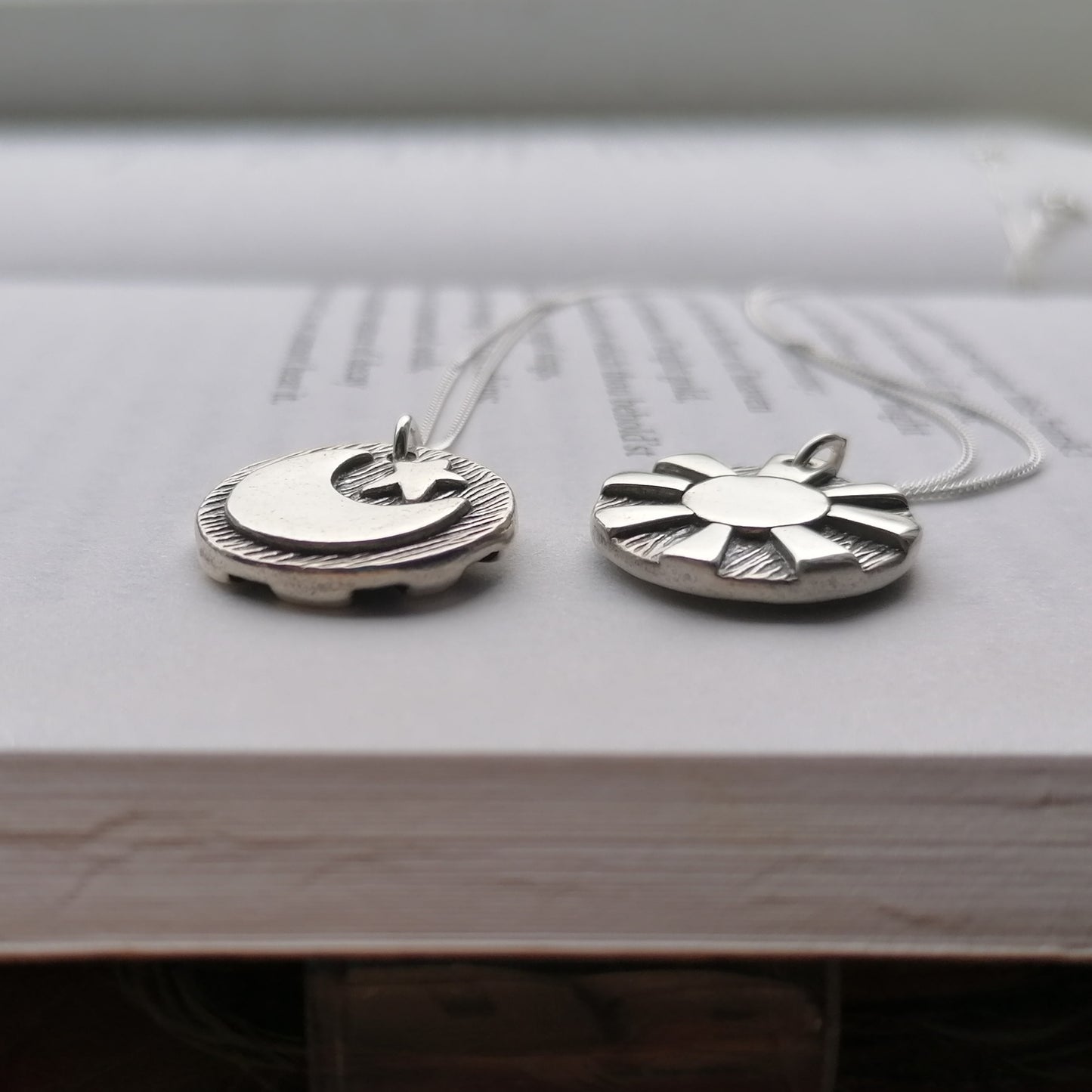 Reversible day and night pendants