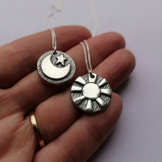 Reversible day and night pendants