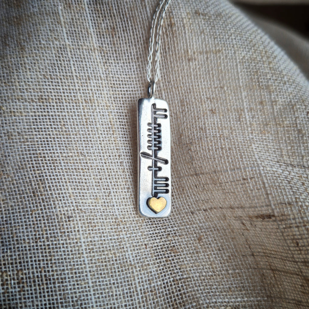 Family ogham pendant with gold heart