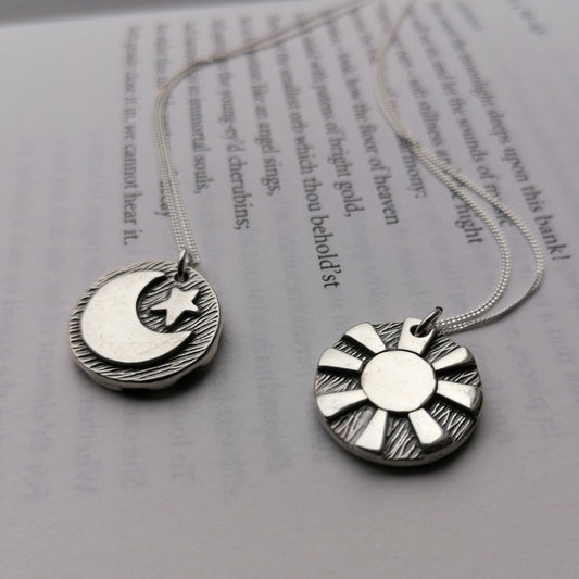 Reversible day and night pendants