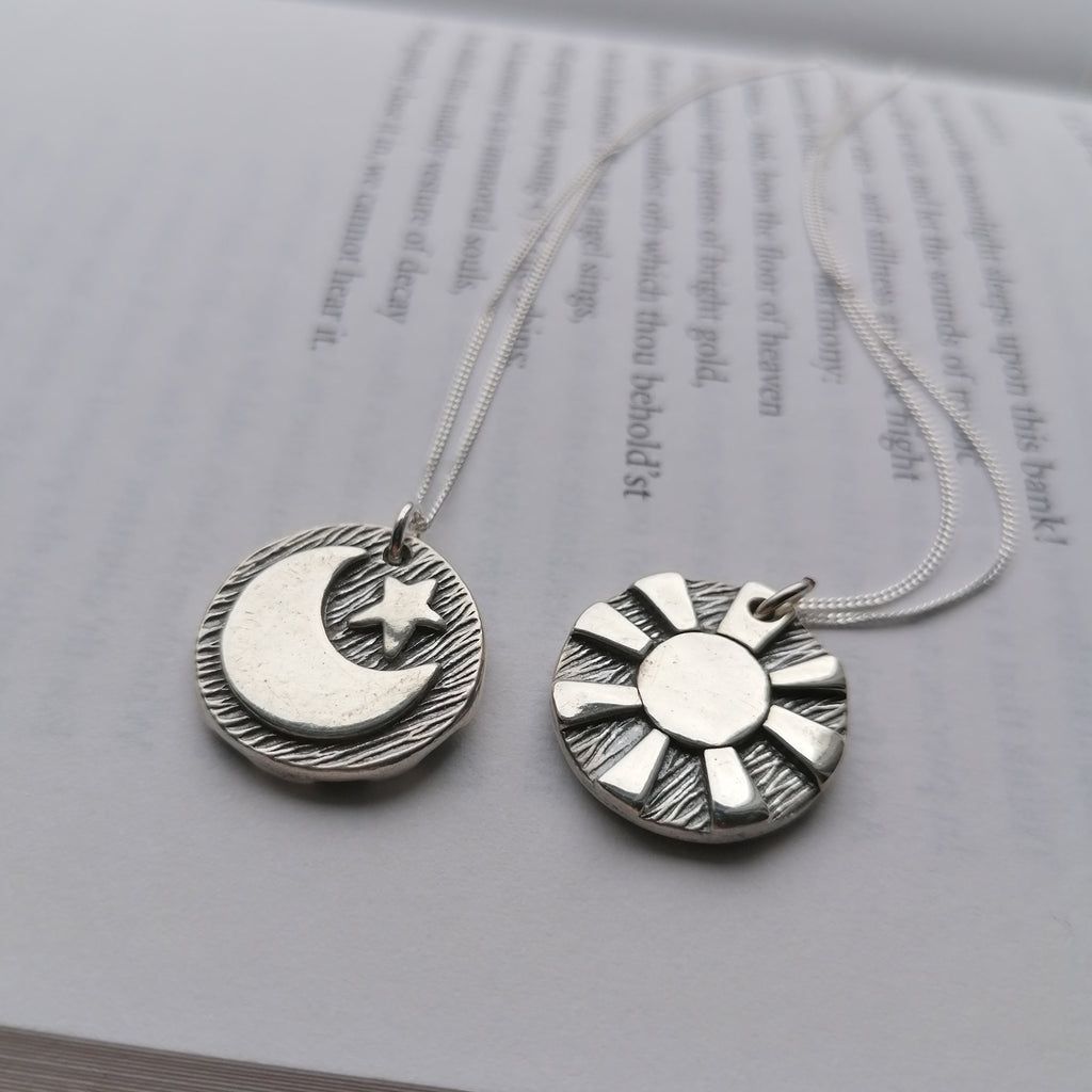 Reversible day and night pendants